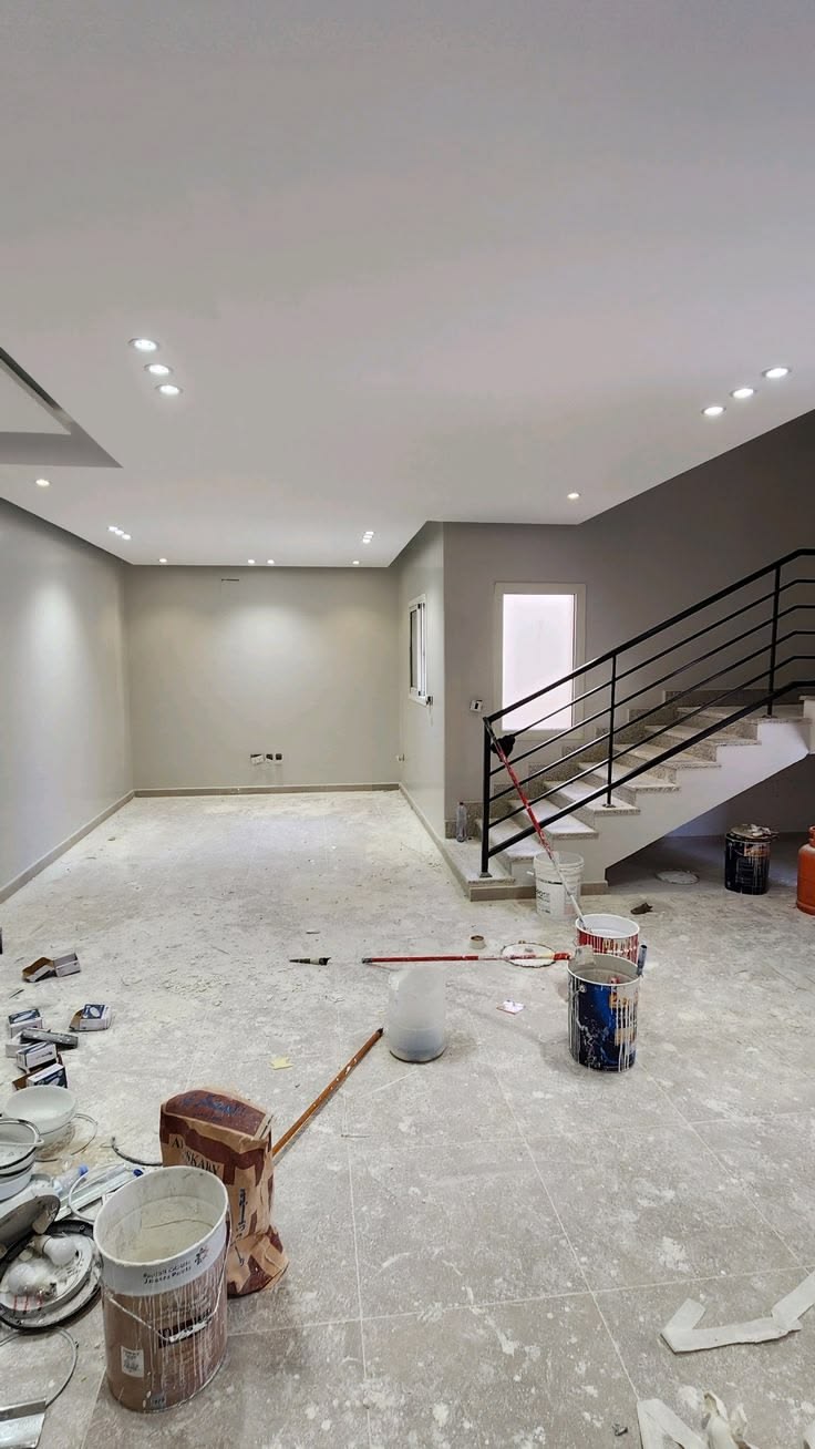 Freshly finished basement with new drywall, paint and staircase