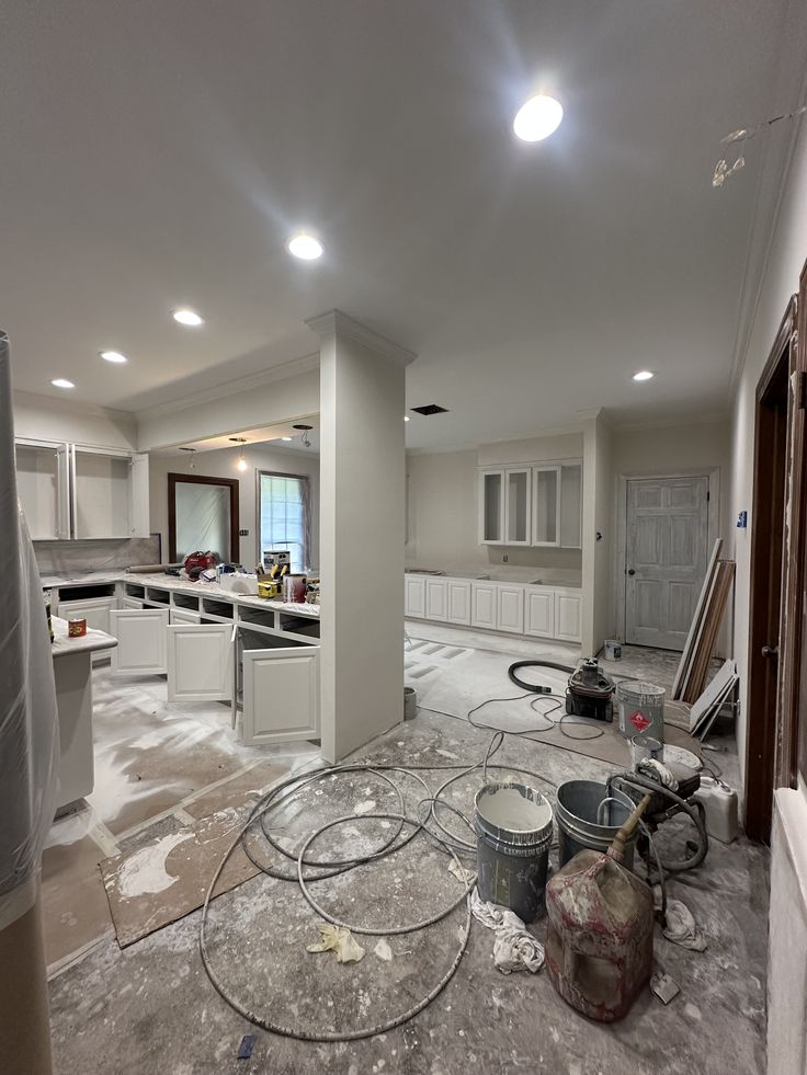 Kitchen cabinetry mid-remodel with fresh drywall and recessed lighting